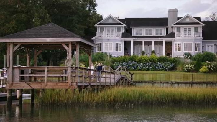 The Summer House from Amazon's The Summer I Turned Pretty — gray-shingled coastal home overlooking the water with private dock and gazebo